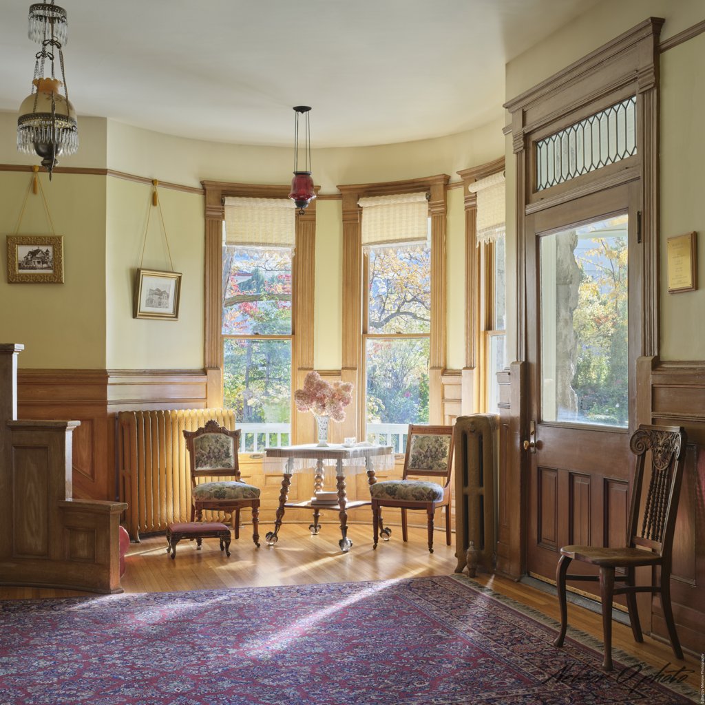 Sunlit bay window sitting area inside the turret parlor